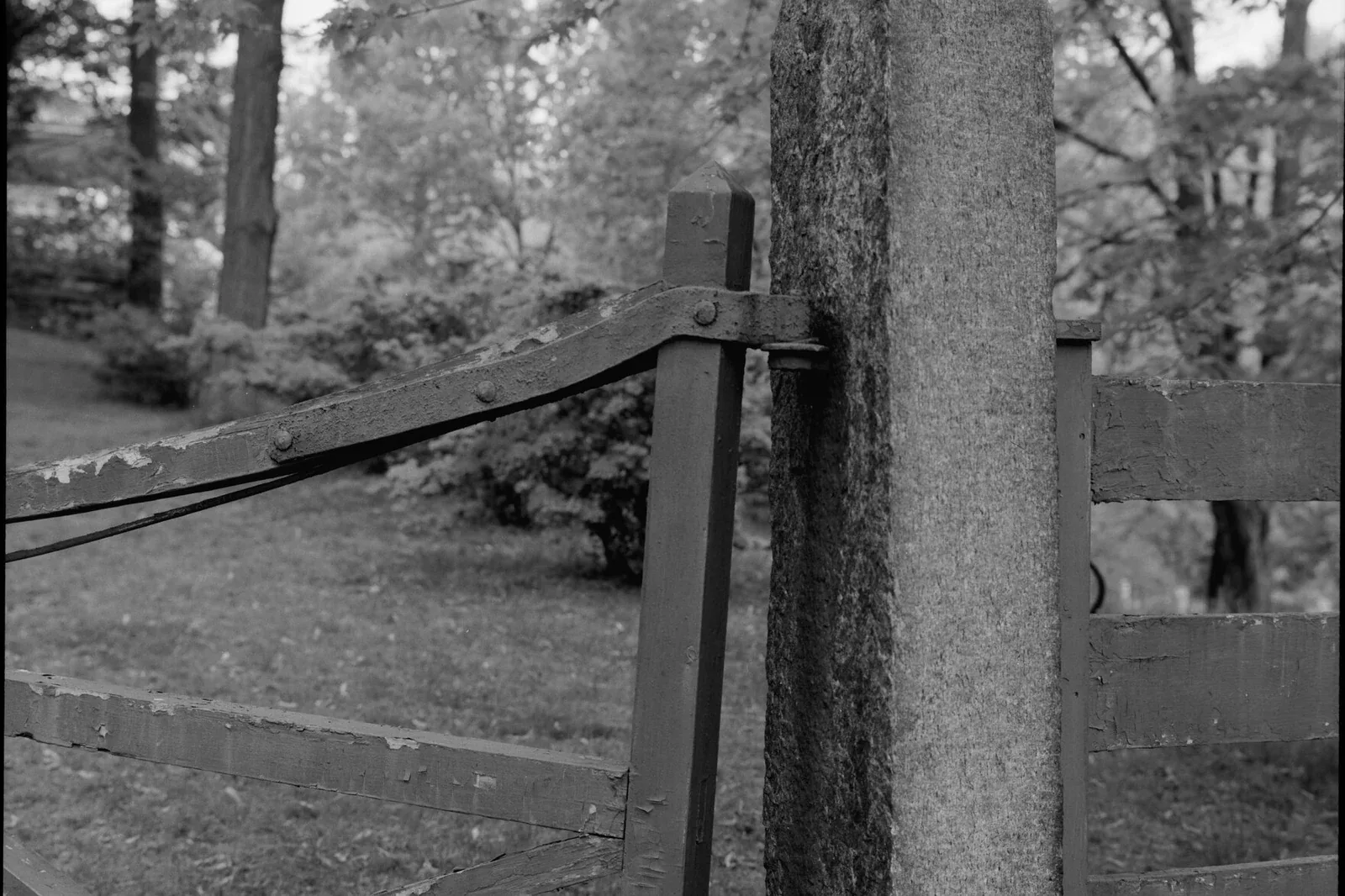 Close view of a wood gate hinge and post alignment